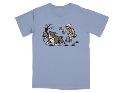 A dog runs with a bone while a skeleton chases it in a graveyard.