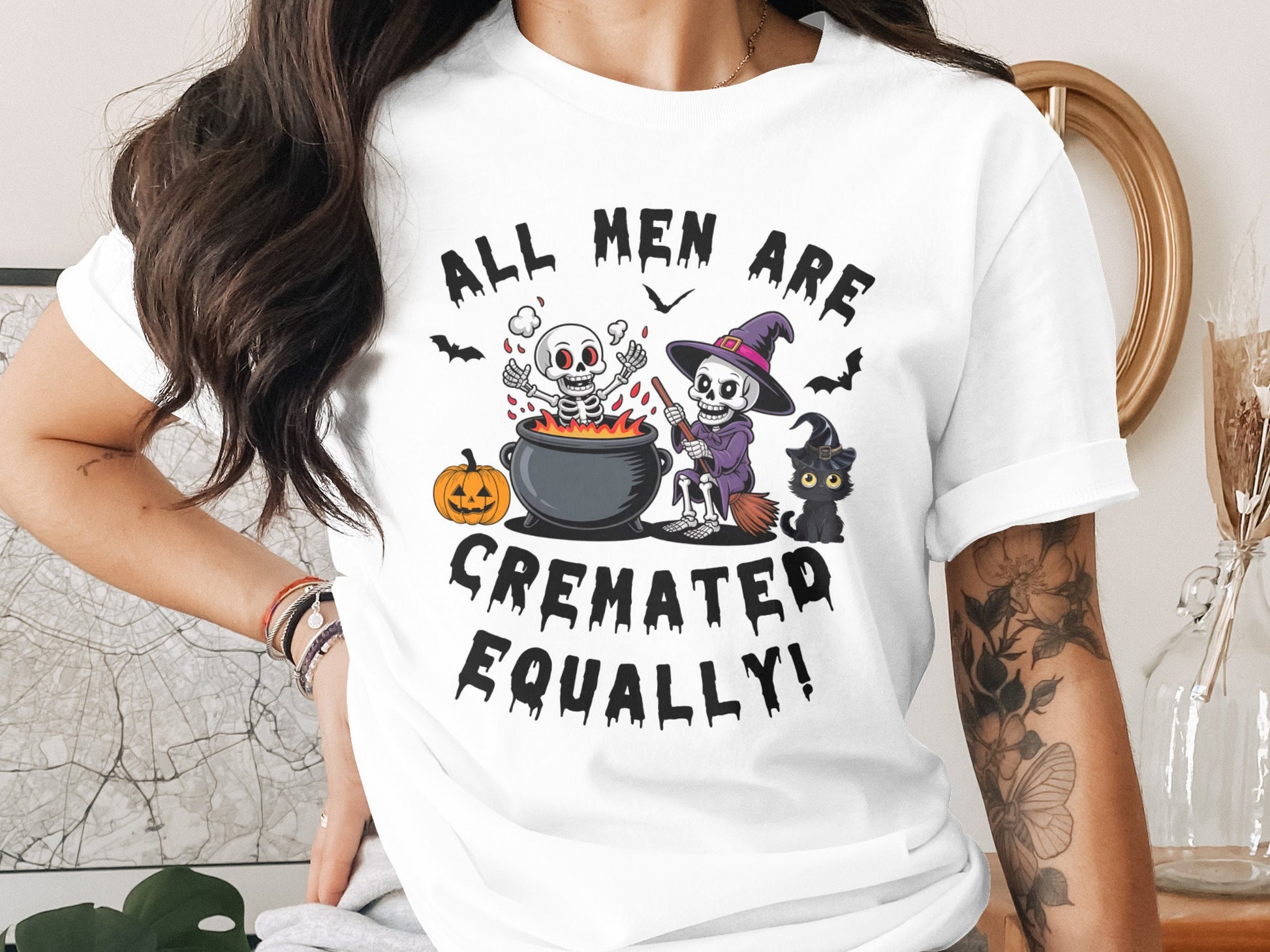 White t-shirt with Halloween graphic and text "ALL MEN ARE CREMATED EQUALLY!".