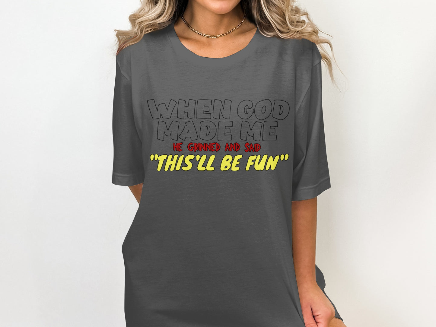 Gray t-shirt with text: "WHEN GOD MADE ME HE GRINNED AND SAID 'THIS'LL BE FUN'"