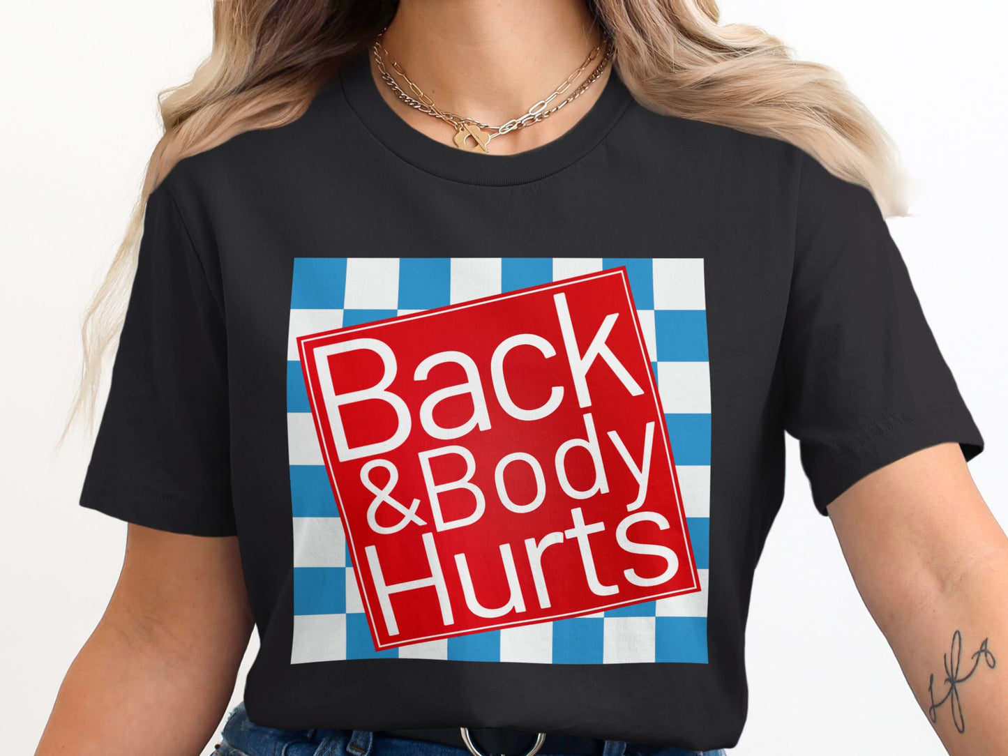 Black t-shirt with a red square graphic reading "Back & Body Hurts" on a blue and white checkerboard.