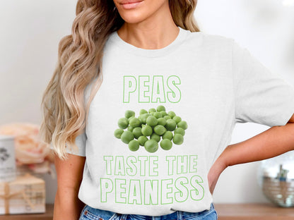 White t-shirt with green text and peas graphic: "PEAS TASTE THE PEANESS".