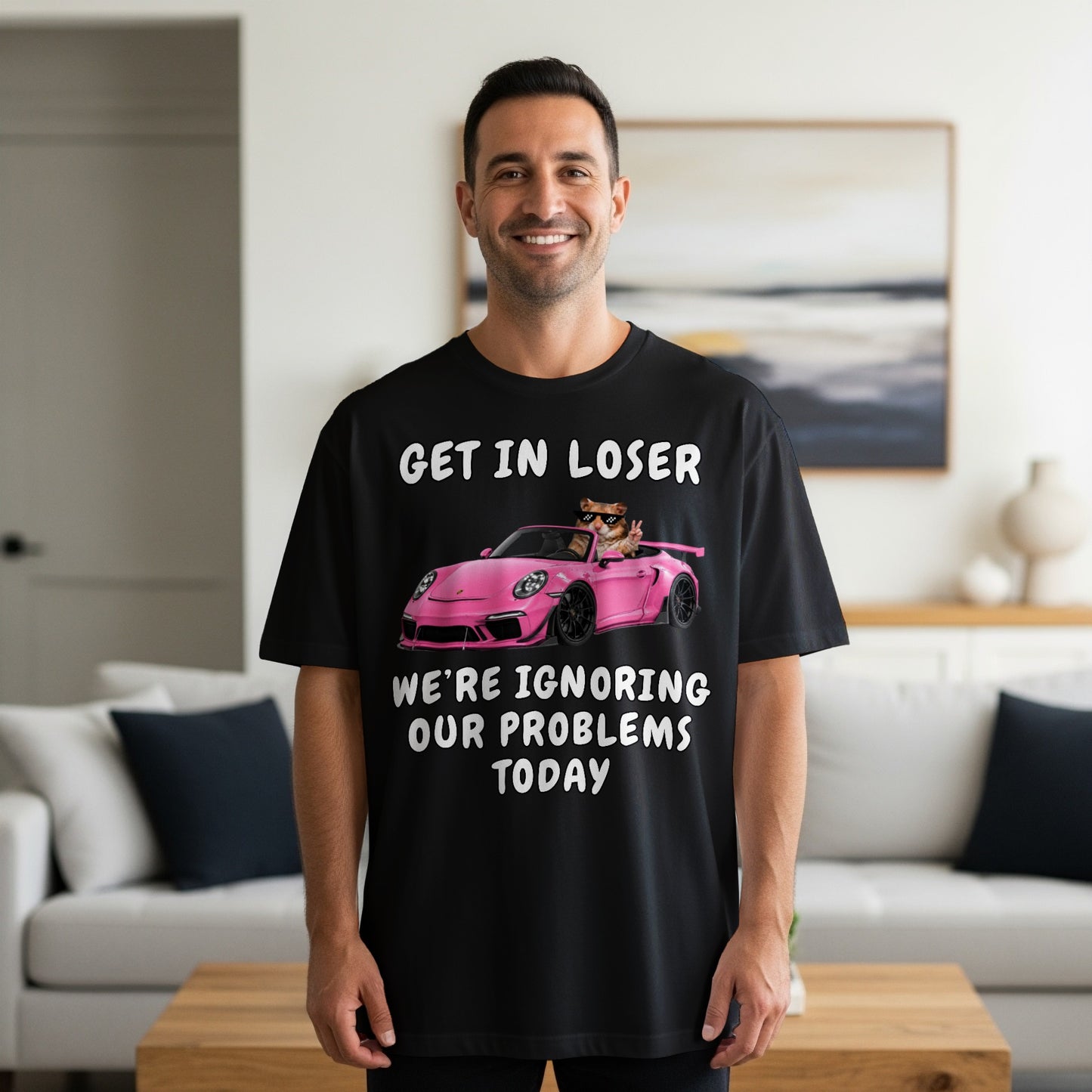 Black t-shirt with text "GET IN LOSER WE'RE IGNORING OUR PROBLEMS TODAY" and a cat in a car.