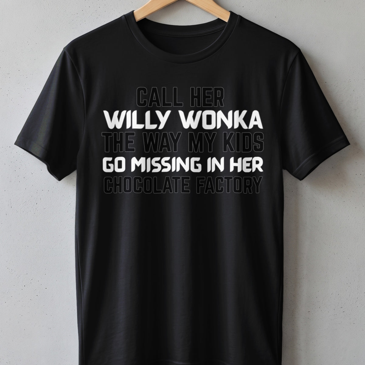 Black t-shirt with text "Call her Willy Wonka the way my kids go missing in her chocolate factory."