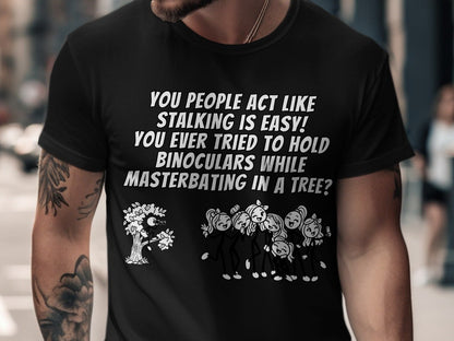 Black t-shirt with text "You people act like stalking is easy!" and stick figures.