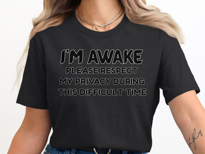 Black t-shirt with white text "I'M AWAKE PLEASE RESPECT MY PRIVACY DURING THIS DIFFICULT TIME".