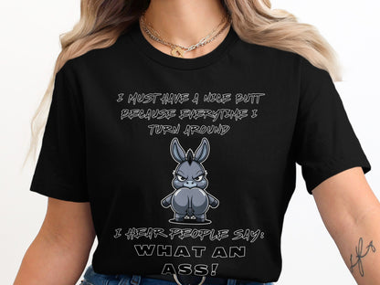 Black t-shirt with cartoon donkey and text: "I MUST HAVE A NICE BUTT BECAUSE EVERYTIME I TURN AROUND I HEAR PEOPLE SAY: WHAT AN ASS!"