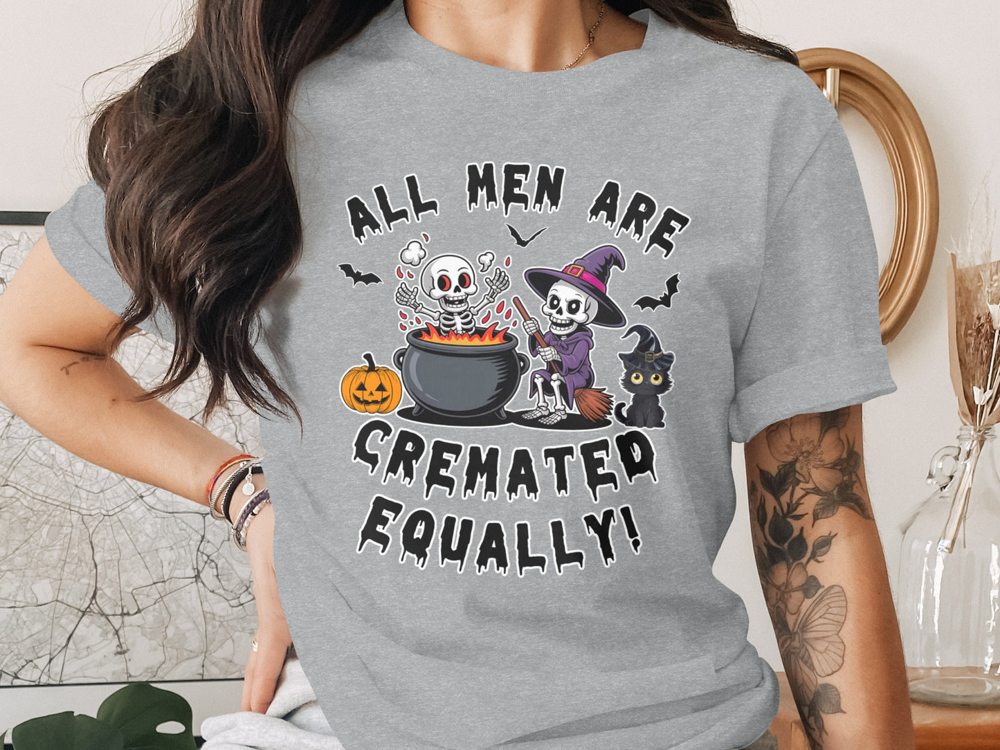 Grey t-shirt with Halloween skeletons, pumpkin, black cat, and text.