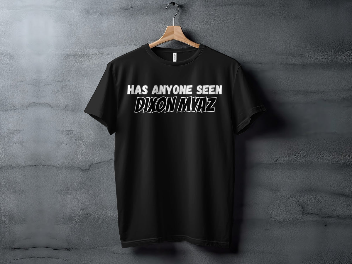 Black t-shirt with white text "HAS ANYONE SEEN DIXON MYAZ" hanging on a rack.