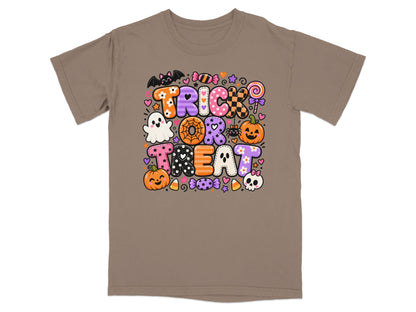 Brown t-shirt with "Trick or Treat" text and Halloween icons including a ghost, bat, pumpkin, and candy.