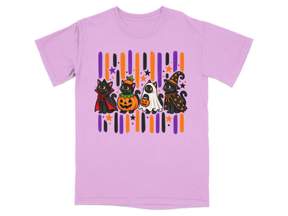 Four cartoon cats in Halloween costumes: vampire, pumpkin, ghost, and witch, on a light purple t-shirt.