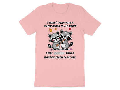 Pink t-shirt with raccoons holding a wooden spoon and humorous text about upbringing.