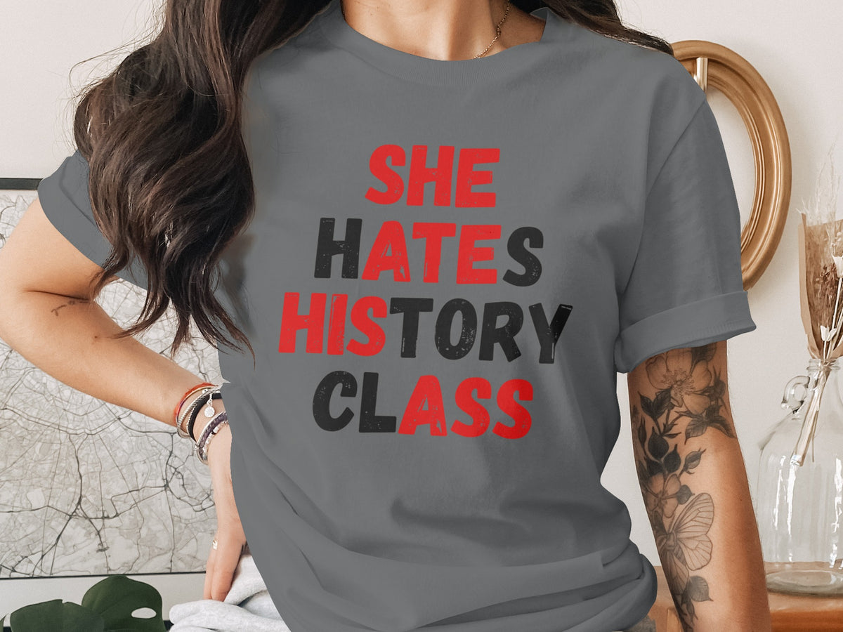 Grey t-shirt with red and black text that reads "SHE HATES HISTORY CLASS."