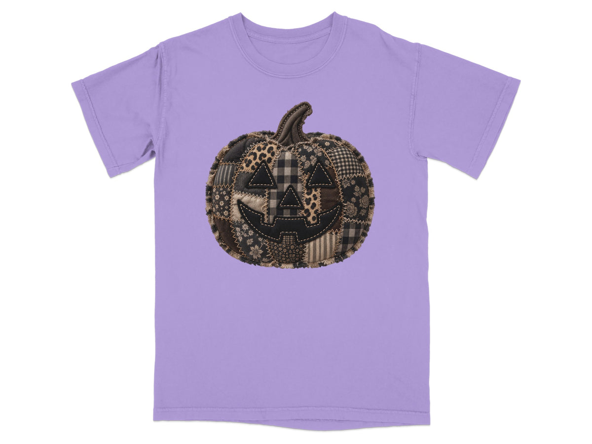 Purple t-shirt with a stitched patchwork jack-o'-lantern graphic on the front.