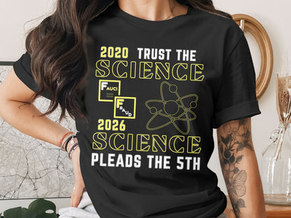 Black t-shirt with text "2020 TRUST THE SCIENCE", "FRAUD", "2026 SCIENCE PLEADS THE 5TH", and an atom graphic.