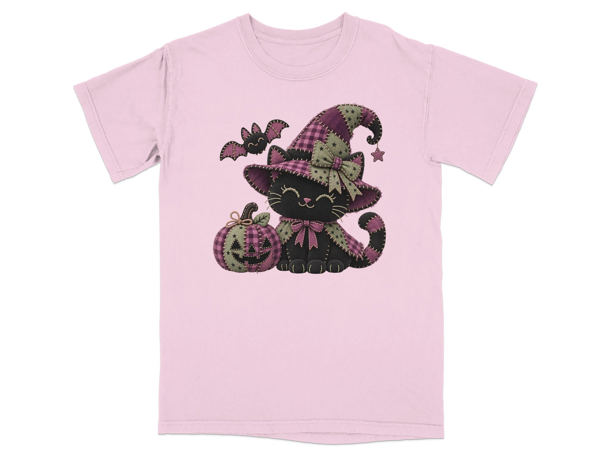 Pink t-shirt with a black cat wearing a witch hat, a pumpkin, and a bat.