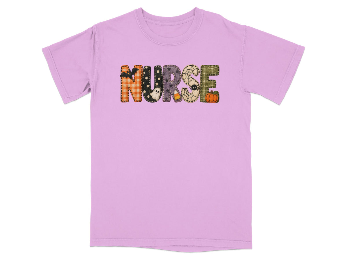 A light purple crewneck t-shirt featuring the word NURSE in Halloween-themed patterned letters.
