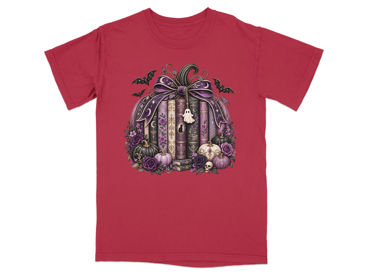 Pumpkin made of books, decorated with purple ribbon, bats, ghosts, skulls, and flowers.