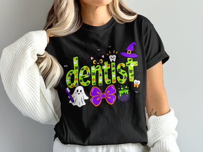 A person wearing a black t-shirt printed with the word dentist in green surrounded by Halloween graphics.