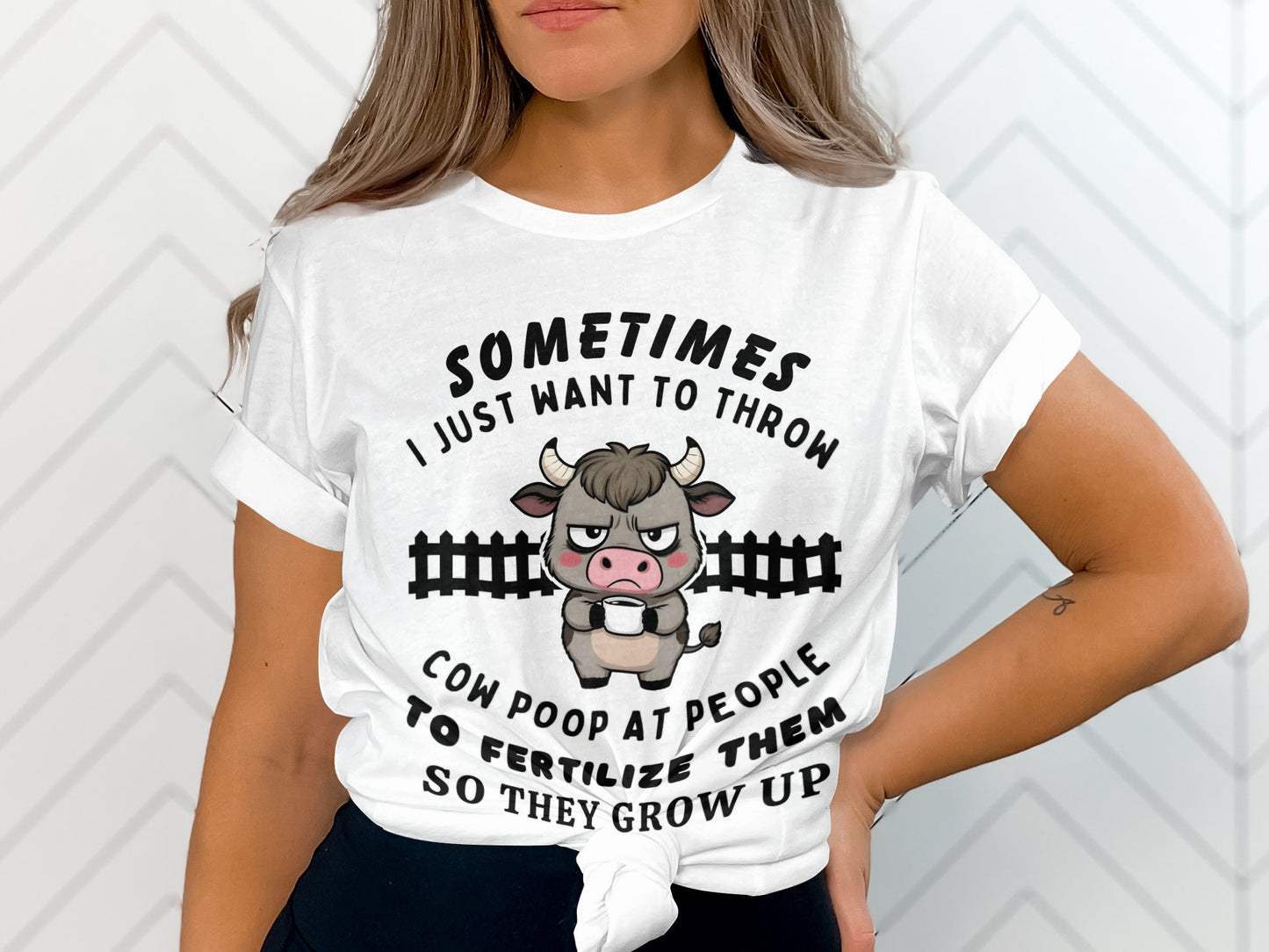 White t-shirt with cartoon cow graphic and text "Sometimes I just want to throw cow poop at people to fertilize them so they grow up."