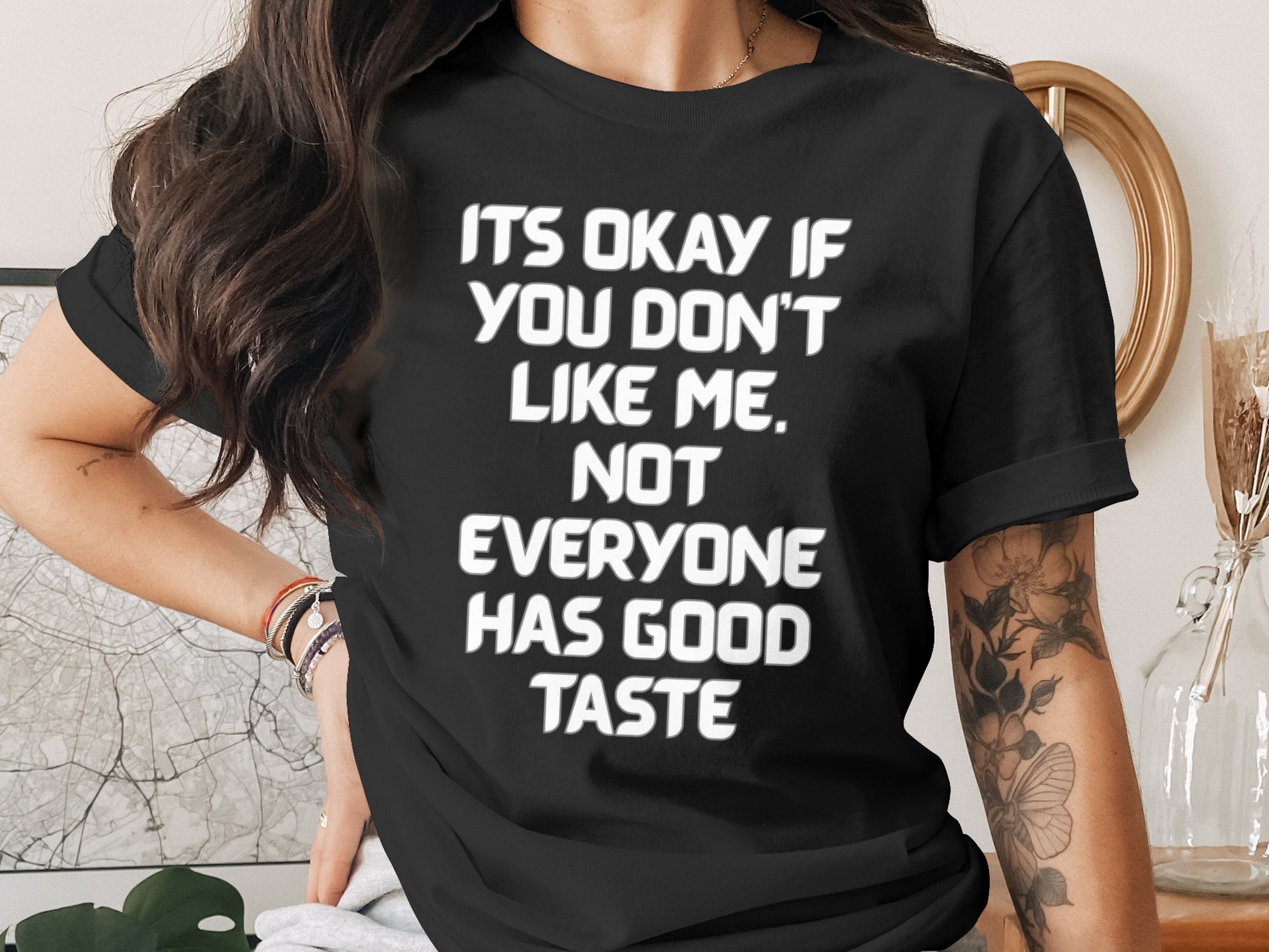 Black t-shirt with white text that reads "ITS OKAY IF YOU DON'T LIKE ME. NOT EVERYONE HAS GOOD TASTE."