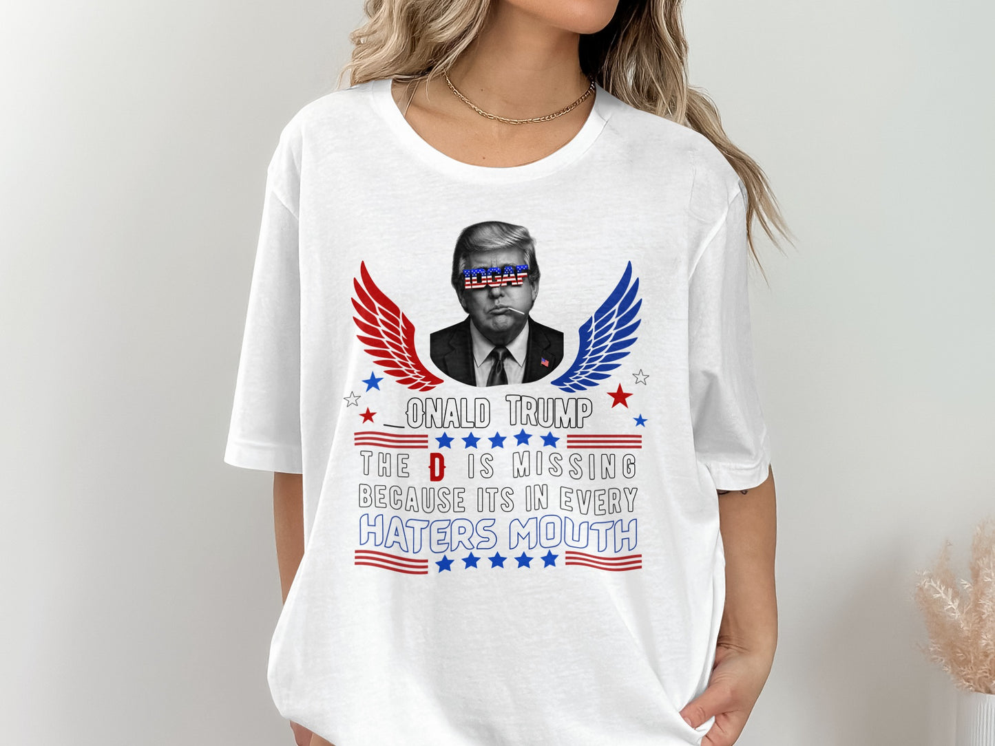 White t-shirt with Donald Trump graphic and text.