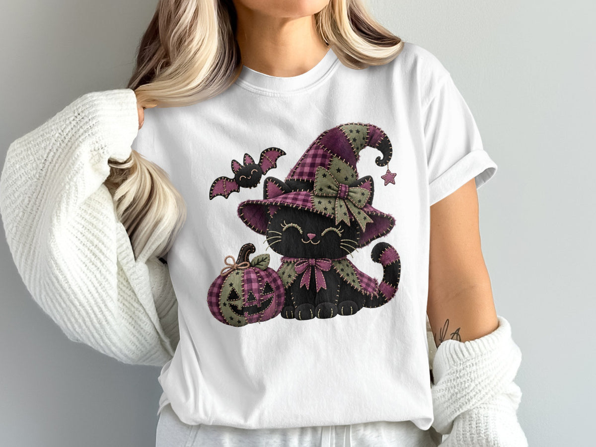 Quilted Halloween cat wearing a witch hat, holding a pumpkin and a bat.