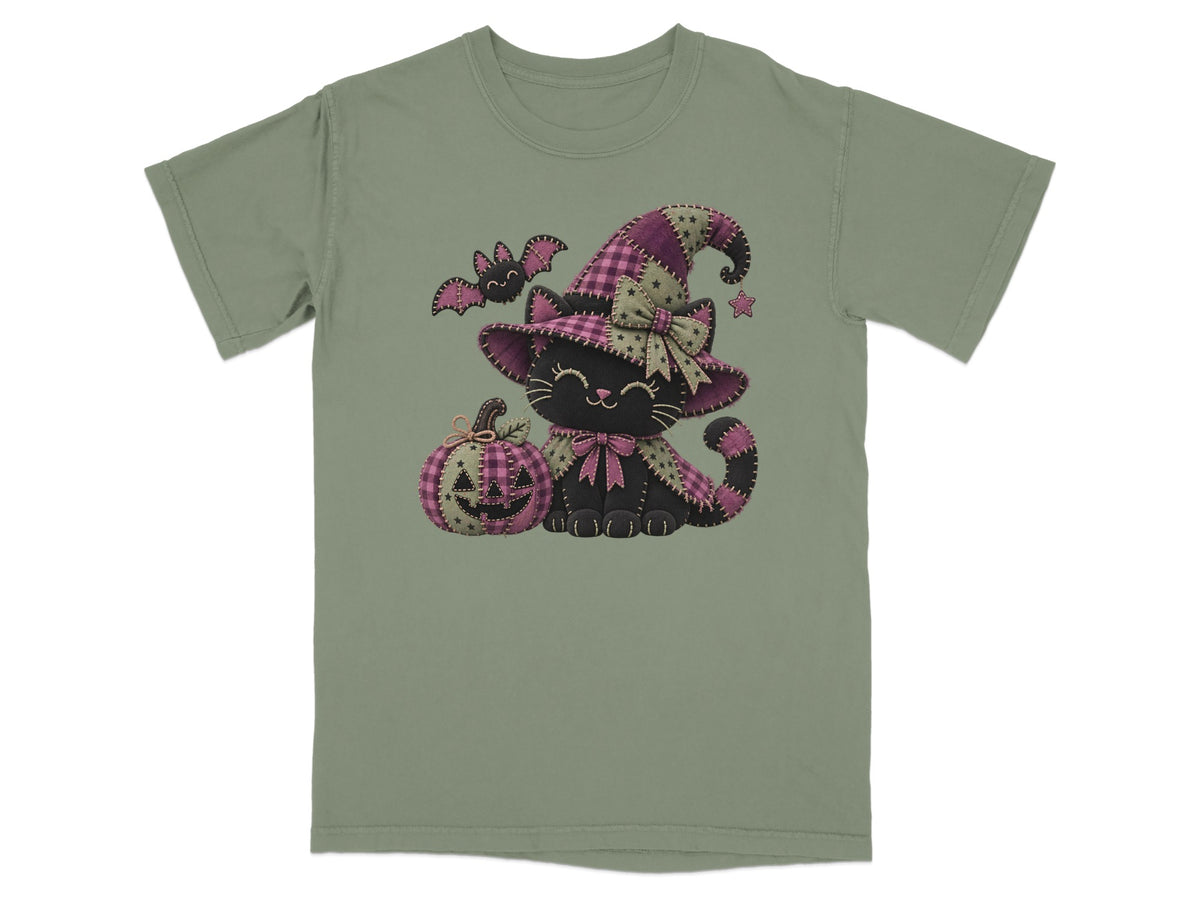 Black cat wearing a witch hat with a pumpkin and bat on a t-shirt.