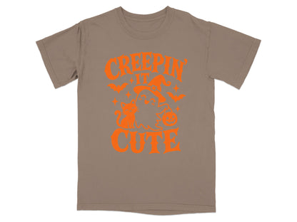 Brown t-shirt with orange Halloween graphic and text "CREEPIN IT CUTE."