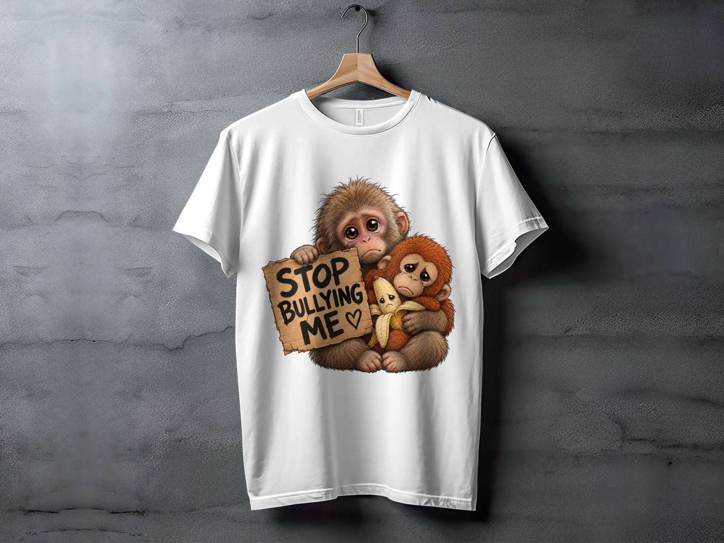 Two sad monkeys embrace, one holding a "Stop Bullying Me" sign and a banana.