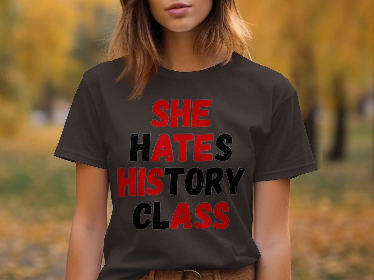 Dark t-shirt with red and black text that reads "SHE HATES HISTORY CLASS".
