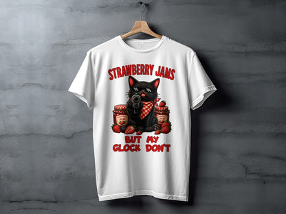White t-shirt with black cat, strawberries, jam jars, and text "STRAWBERRY JAMS BUT MY GLOCK DON'T".