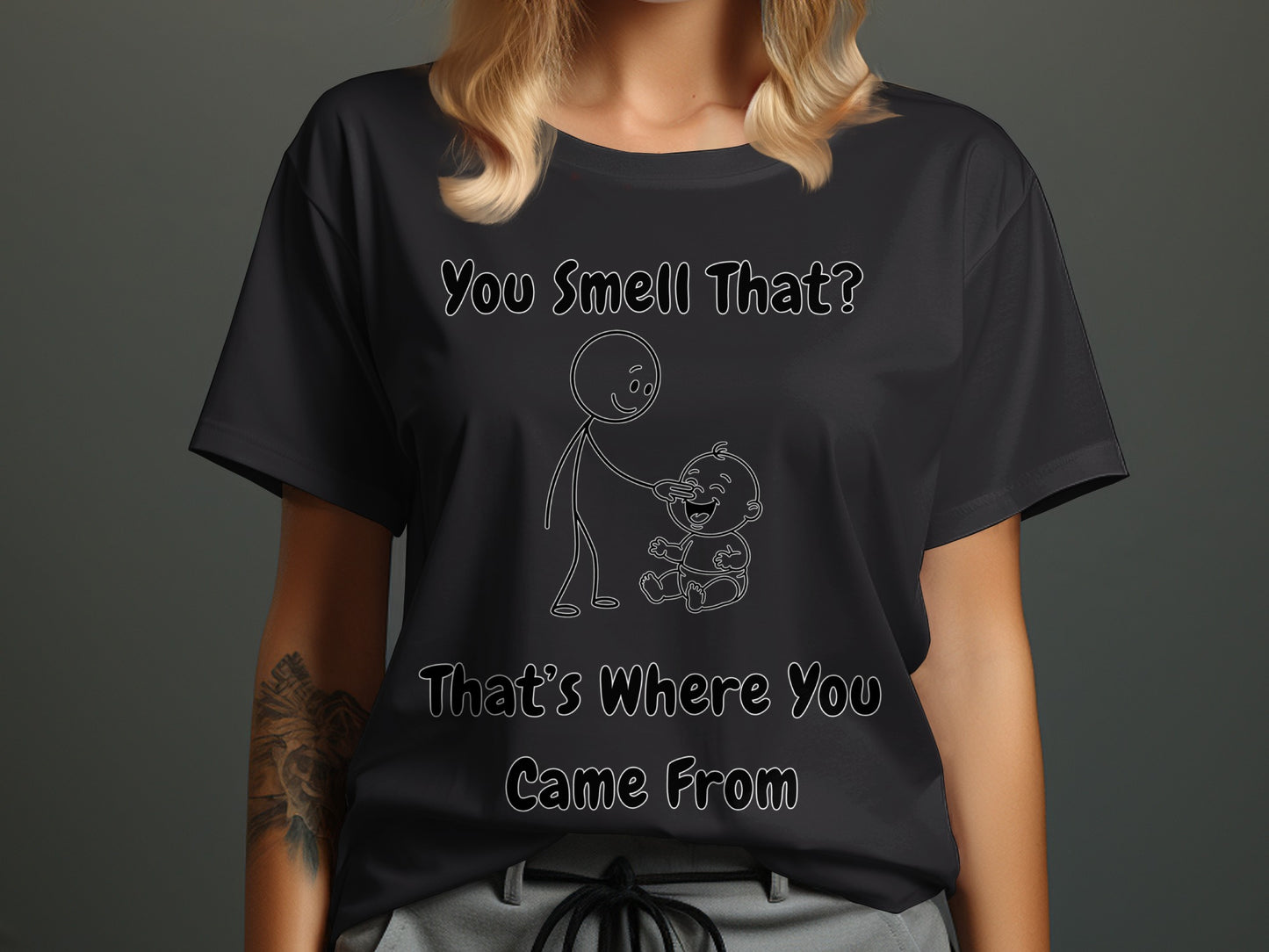 Black t-shirt with white text "You Smell That? That's Where You Came From" and a drawing of a stick figure and a baby.