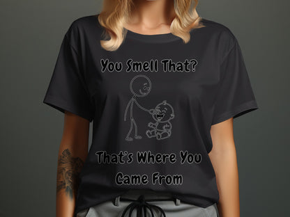 Black t-shirt with white text "You Smell That? That's Where You Came From" and a drawing of a stick figure and a baby.