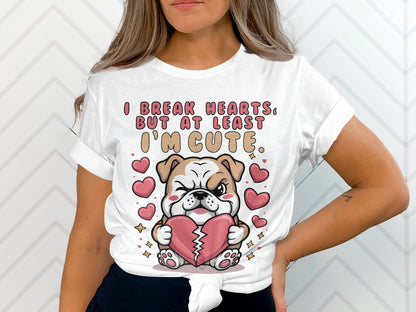 White t-shirt with a bulldog holding a broken heart and text "I break hearts, but at least I'm cute."
