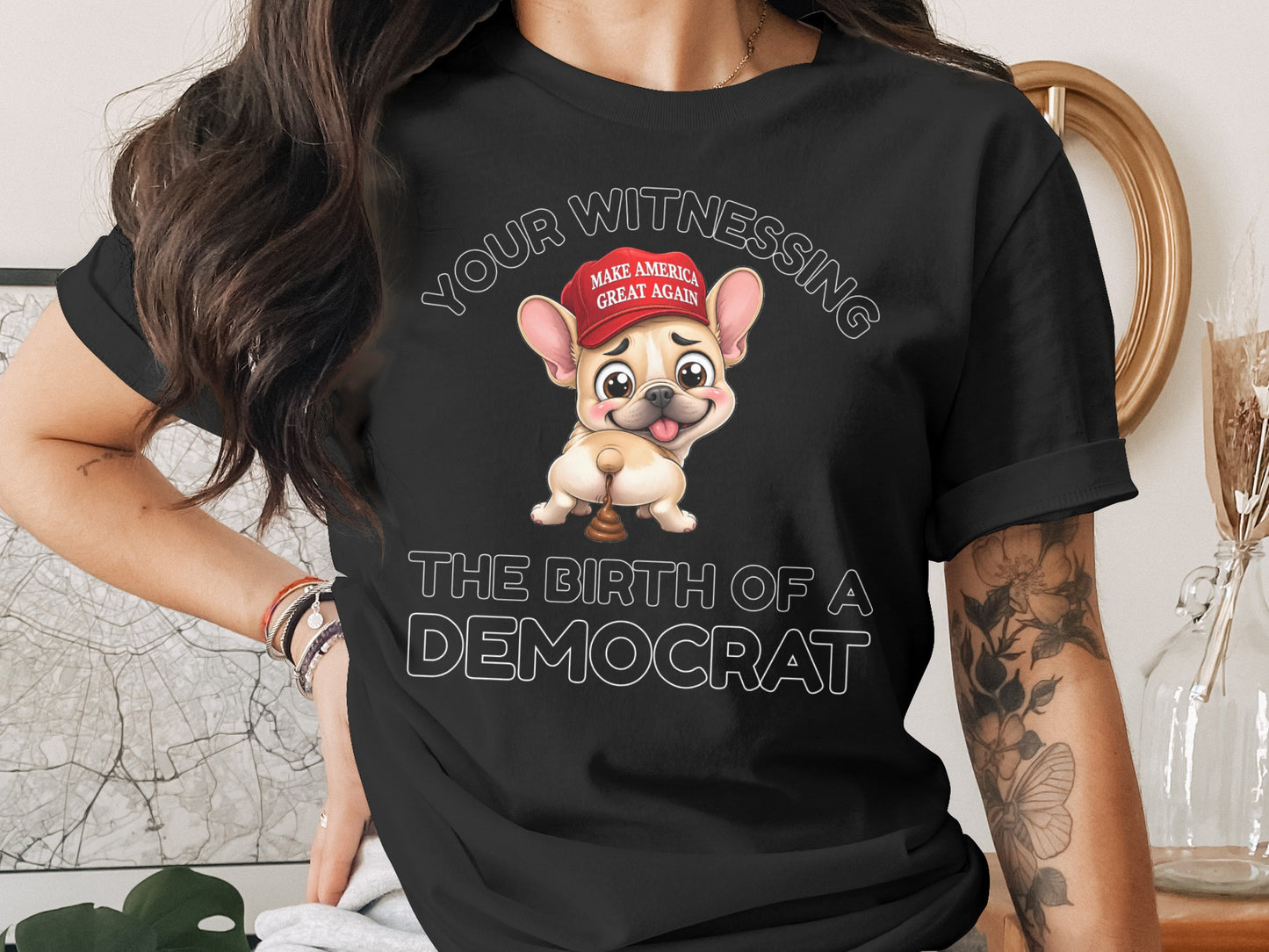 Black t-shirt with cartoon French bulldog wearing "Make America Great Again" hat, text: The Birth of a Democrat