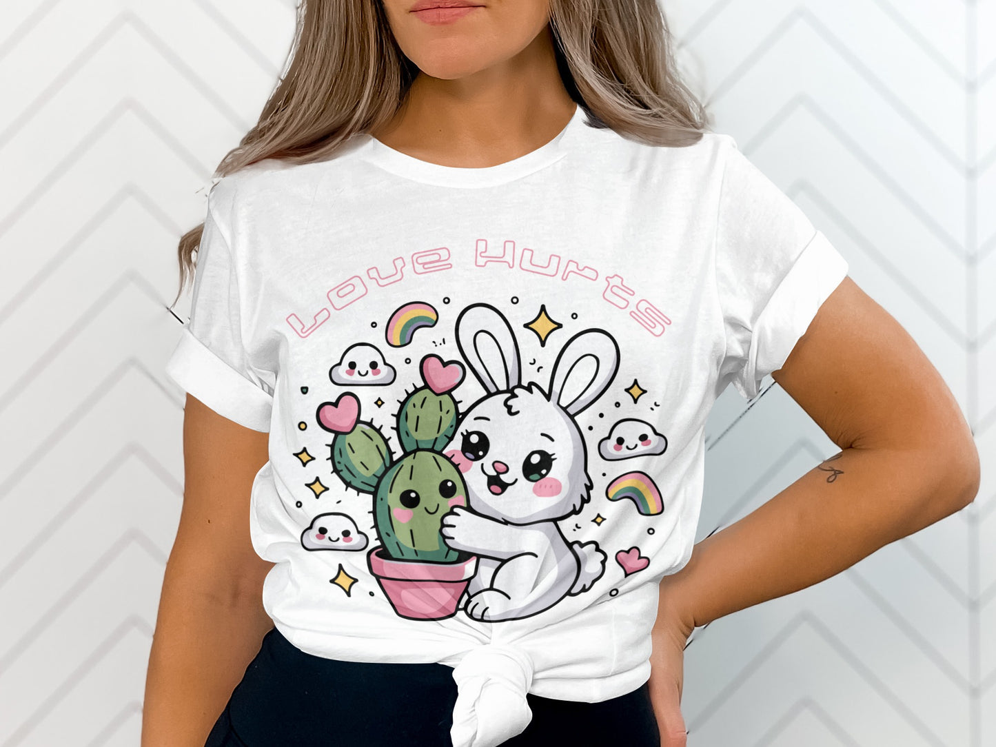 White t-shirt with a cartoon bunny hugging a cactus, text reads "Love Hurts."