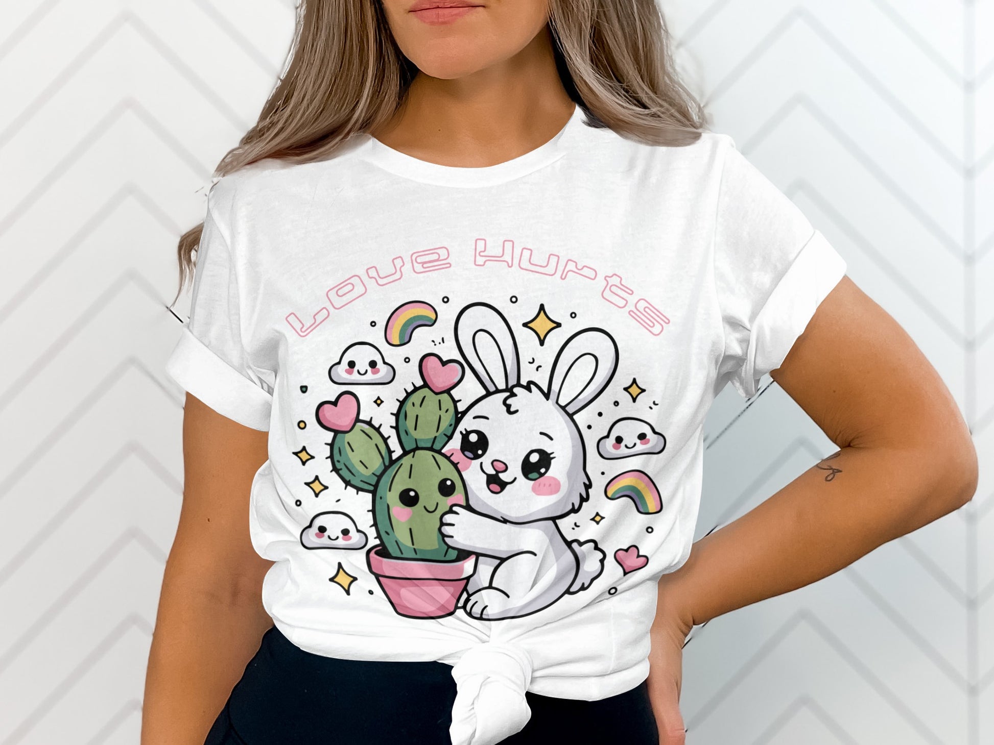 White t-shirt with a cartoon bunny hugging a cactus, text reads "Love Hurts."