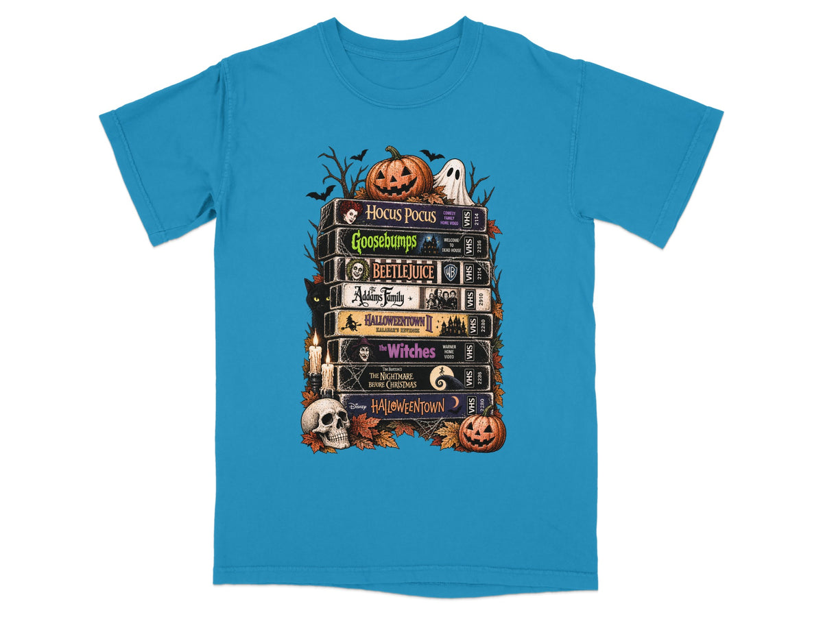 Halloween movies stacked on VHS tapes with pumpkins, ghost, and skull decorations.