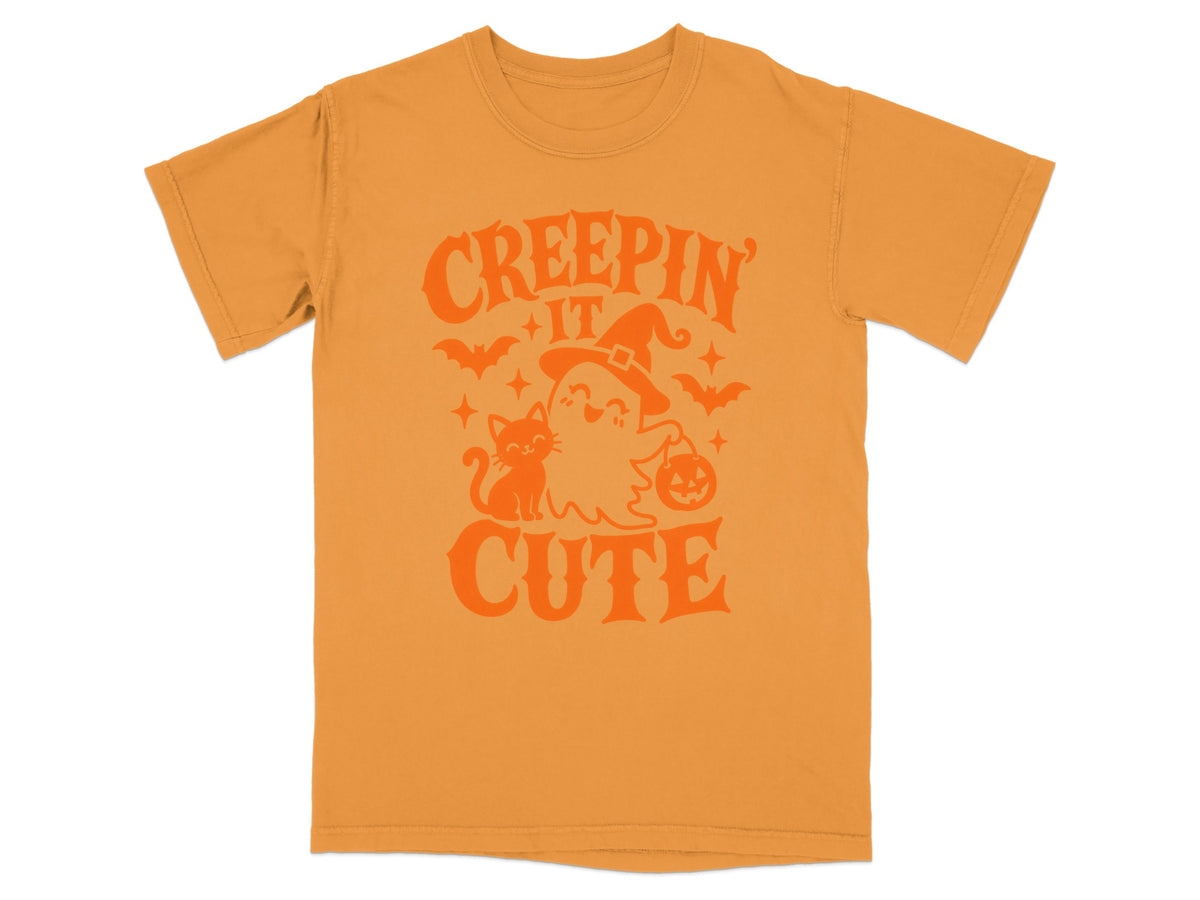 Orange t-shirt with "Creepin' It Cute" Halloween graphic featuring a ghost and cat.