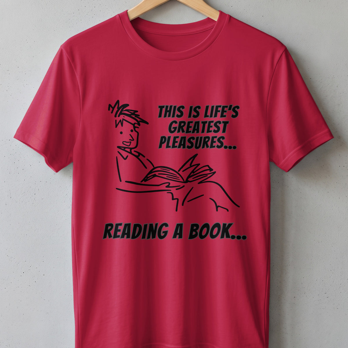 Red t-shirt with black text and line art of a person reading a book.