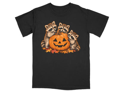 Three raccoons peek over a jack-o'-lantern with autumn leaves.