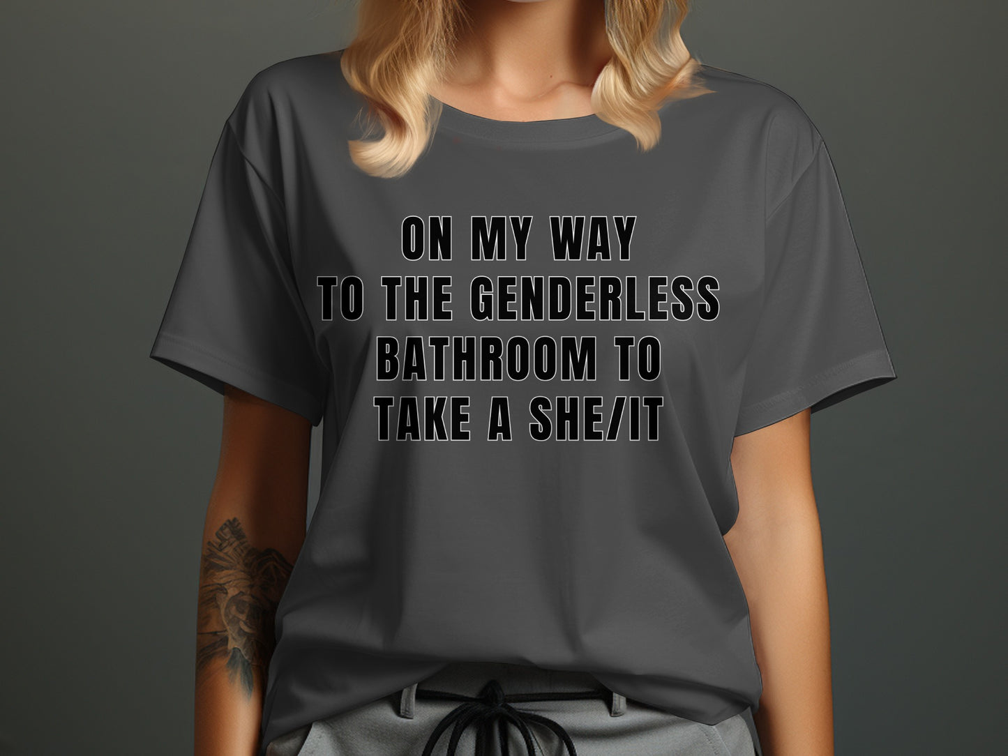 Grey t-shirt with text "ON MY WAY TO THE GENDERLESS BATHROOM TO TAKE A SHE/IT".