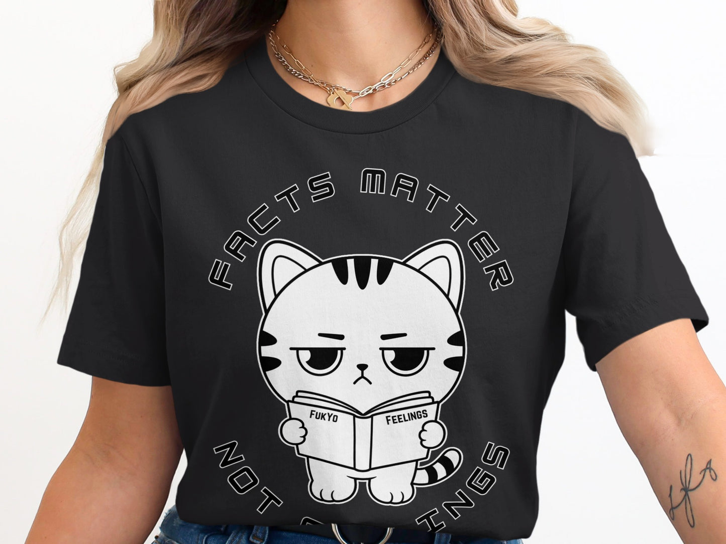 Black t-shirt with cartoon cat reading "Fukyo Feelings" book, "Facts Matter" text.