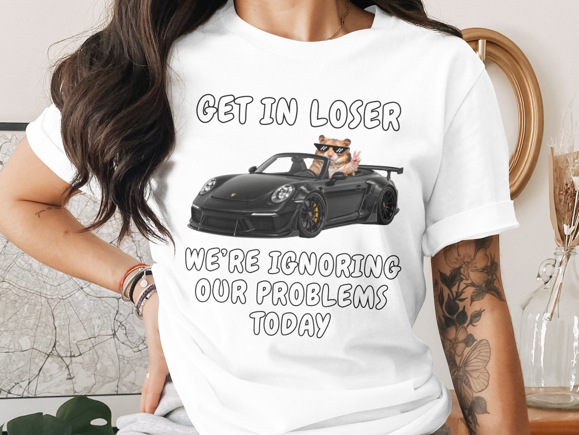 T-shirt with text "GET IN LOSER WE'RE IGNORING OUR PROBLEMS TODAY" and a hamster in a car.