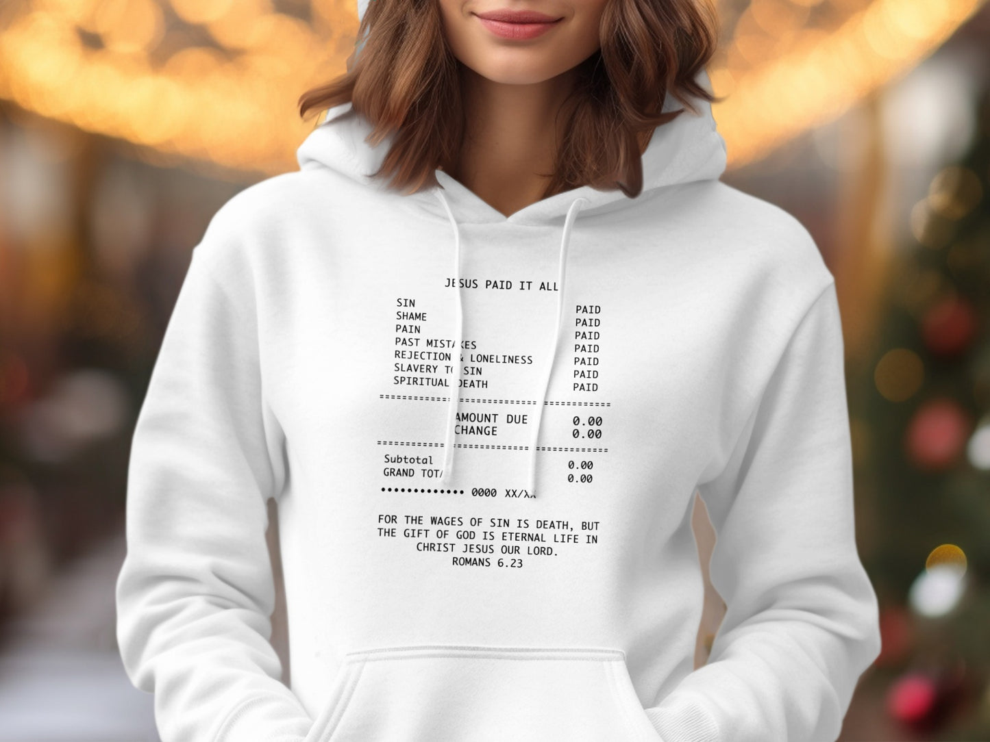 White hoodie with "Jesus Paid It All" text, listing sins and the Bible verse Romans 6:23.