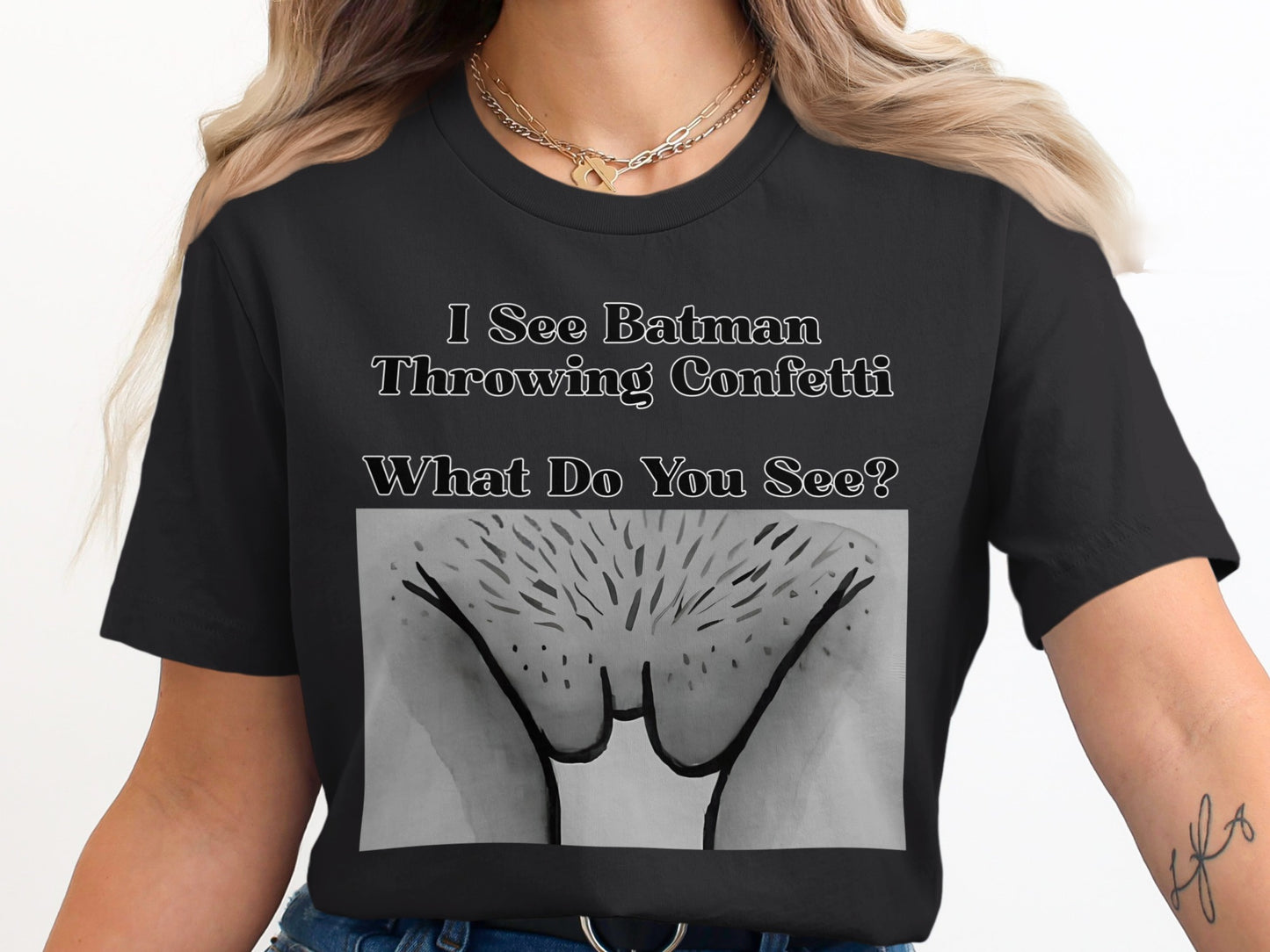 Black t-shirt with text "I See Batman Throwing Confetti What Do You See?" and a drawing.