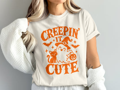 T-shirt with "CREEPIN' IT CUTE" and Halloween graphic of a ghost, cat, and bats.