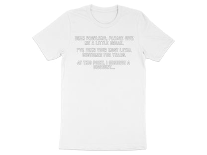 White t-shirt with text: "Dear problems, please give me a little break. I've been your most loyal customer for years. At this point, I deserve a discount..."
