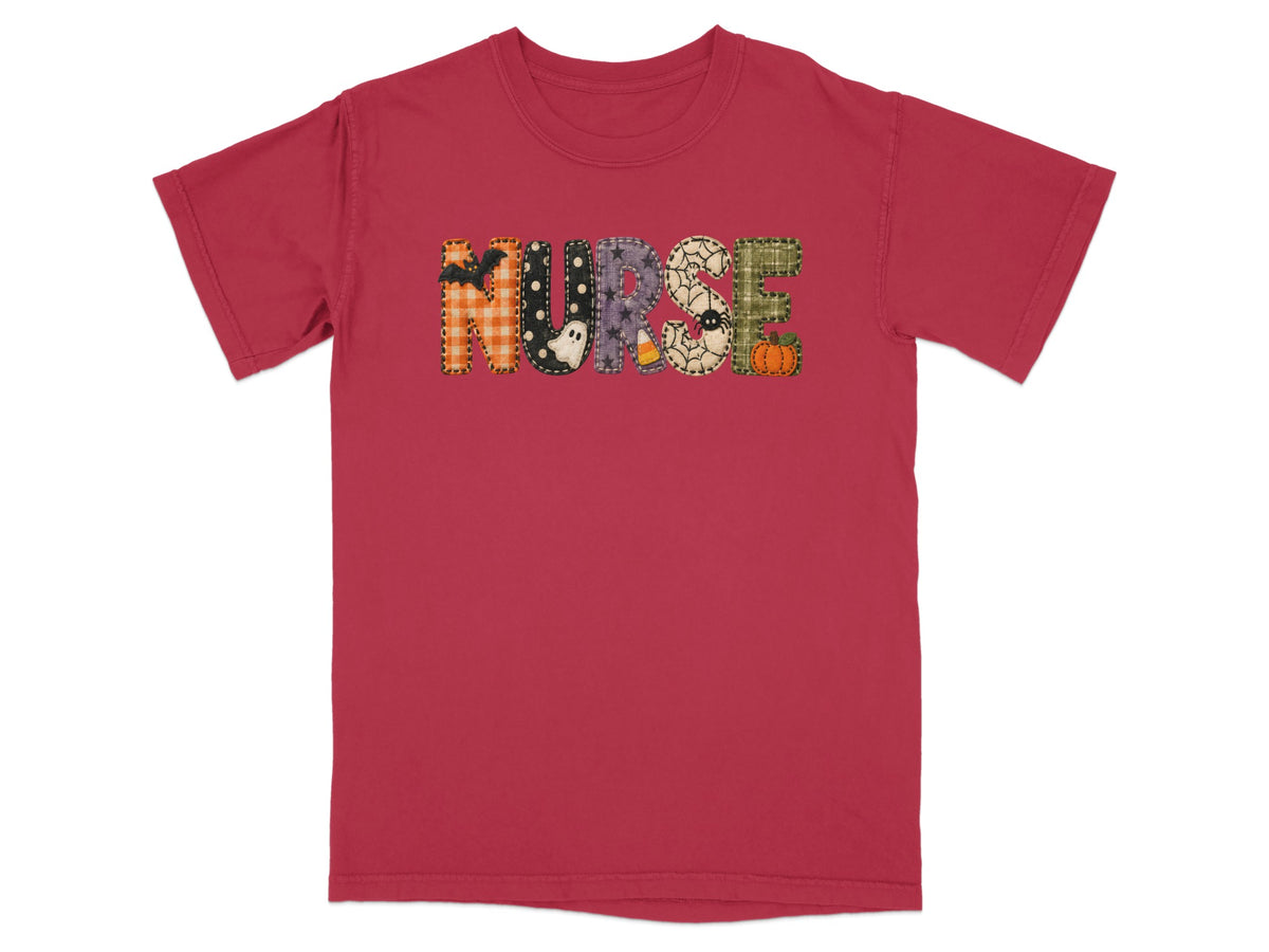 A red short-sleeved t-shirt features the word NURSE in patterned Halloween-themed block letters across the chest.