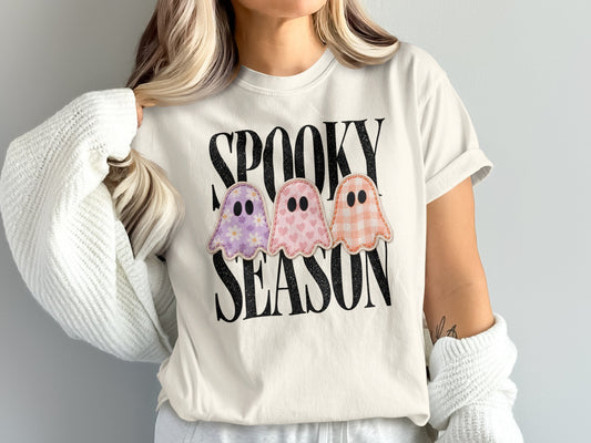 White t-shirt with "SPOOKY SEASON" text and three embroidered ghosts.